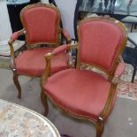 A pair of French upholstered open-arm bedroom chairs, on cabriole legs