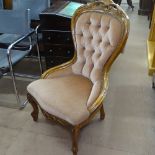 A carved beech-framed and button-back upholstered nursing chair