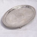 A George III oval silver teapot stand, with bright-cut decoration on 4 scrolled feet, by Thomas
