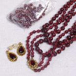 A 2-strand polished garnet bead necklace with 9ct gold mount, together with a pair of 9ct gold