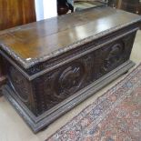 An 18th century Continental oak coffer, the relief carved front decorated with knights in armour,