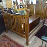 A stylised Arts and Crafts oak double bed, the head and foot boards having stylised pierced and