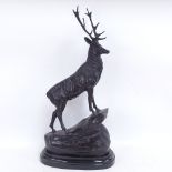 After Joules Moigniez, a patinated bronze sculpture depicting stag on a rocky outcrop, on polished