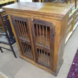A hardwood side cabinet, with 2 iron spindle panelled doors, W95cm, D38cm, H116cm