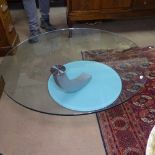 A contemporary designer glass coffee table, the clear glass on curved support over frosted glass