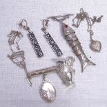 A silver articulated fish design brooch, miniature silver jug, engraved silver locket, a pair of