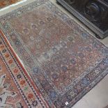 An Antique red ground Persian rug, symmetrical pattern and border, 190cm x 120cm