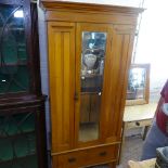 An Edwardian satin-walnut single mirror-door wardrobe, with drawer to the base, W95cm, D45cm, H198cm