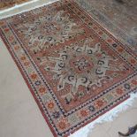 A cream ground Caucasian rug with symmetrical pattern, 175cm x 120cm