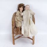 A Vintage Armand Marseille porcelain-headed baby doll, another marked BST, and a child's wicker