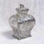 A 19th century French silver tea caddy of rectangular baluster form, with relief embossed scenes,