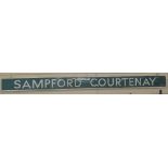 A Vintage green and white enamel Sampford Courtenay enamel railway sign, mounted on wood backing,