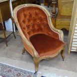 A Victorian walnut-framed and button-back armchair