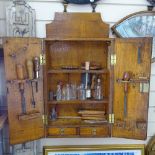 A Victorian panelled oak carpenter's tool cabinet, with label for Sheffield Works, and some tools