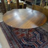 A mid-century circular teak dining table, on hairpin legs, W137cm , H73cm