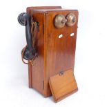 A Vintage wall-mounted oak crank box telephone, with Bakelite Siemens handset and full interior