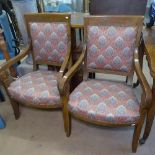 A pair of early 19th century mahogany-framed open armchairs