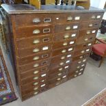 A Victorian stained pine bank of 33 drawers, with brass cup handles, W135cm, D35cm, H129cm