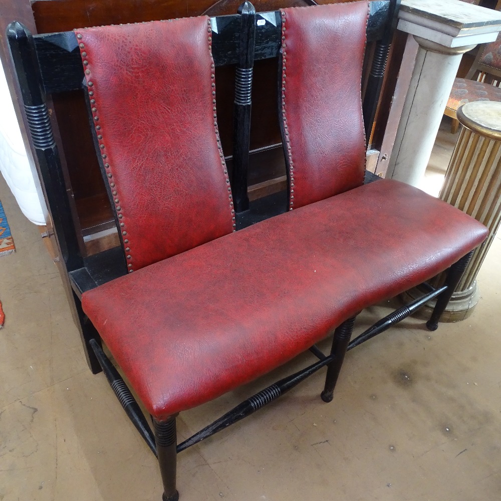 A William Birch Arts and Crafts ebonised oak bench, with curved slat-back, later upholstery, W115cm,