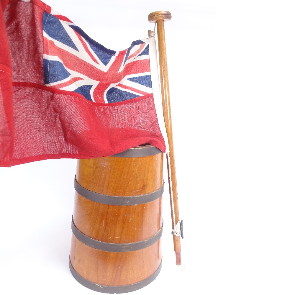 A tapered coopered oak stick stand, a ship's pennant flag, and 2 brass pricket candlesticks, stick