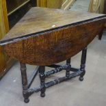 An Antique oak corner table, with single drop leaf, on turned legs, W90cm, D45cm, H69cm