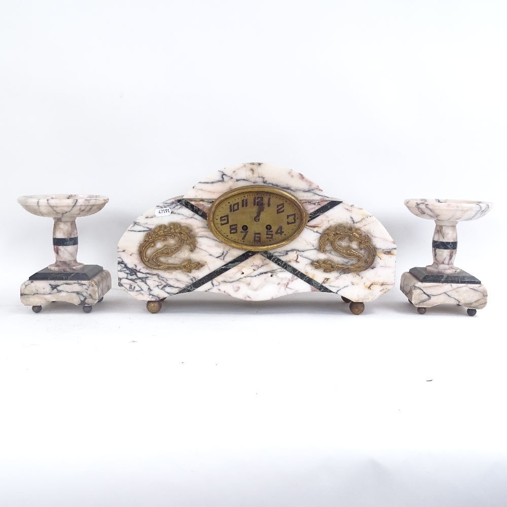 An Art Deco pink marble 3-piece clock garniture, with sectional case and brass mounts, clock