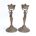 A pair of nautical brass swivel candlesticks/oil burners, height 25cm