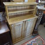 A Victorian pitched pine cabinet with raised shelf-back, 2 panelled doors under, W97cm, D41cm,
