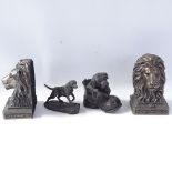 A pair of composition lion-head bookends, resin Pointer dog sculpture, and resin dog in shoe