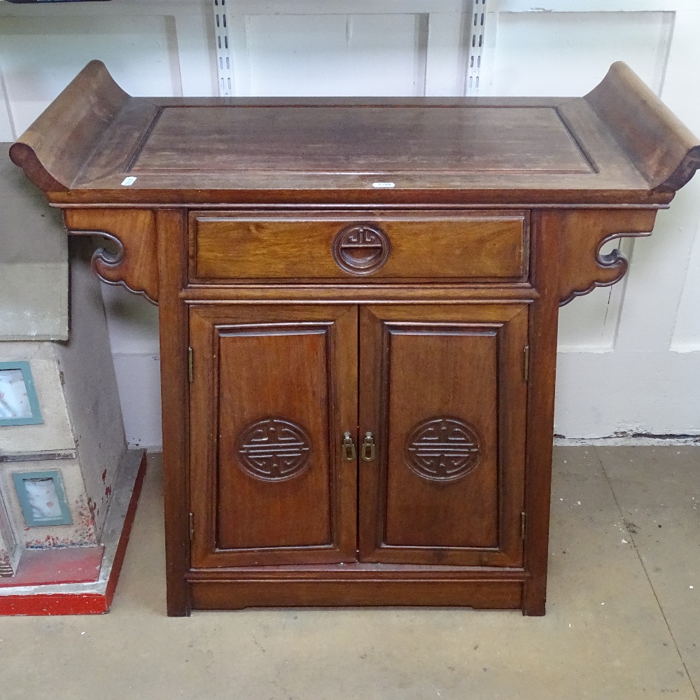 A Chinese hardwood altar cabinet, with drawer and panelled doors, W80cm, H78cm