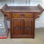 A Chinese hardwood altar cabinet, with drawer and panelled doors, W80cm, H78cm