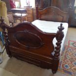 A Victorian panelled mahogany 4' 6" bed, with spiral turned columns and applied decoration, L215cm