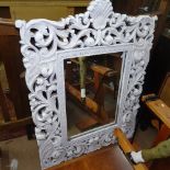 A French painted wall mirror, in a scrolled carved and pierced frame, W92cm, H123cm