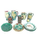 A collection of Majolica ceramic jugs and plates, including corn on the cob and leaf plates