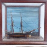 A scratch-built hand painted 2-masted model ship, in glazed and painted display case, case height