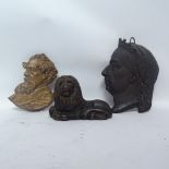 A black painted cast-iron recumbent doorstop, cast-iron profile plaque of Queen Victoria, and