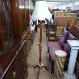 A carved and fluted stained pine standard lamp with tasseled shade, height including shade 178cm