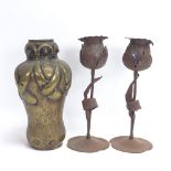 A pair of German Arts and Crafts Hugo Goberg iron tulip candleholders, and an Art Nouveau trench art