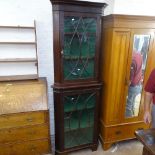 An Edwardian mahogany 2-section corner cabinet, in Chippendale style, with blind carved fretwork