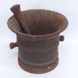 A large 19th century cast-iron pestle and mortar, mortar height 25cm