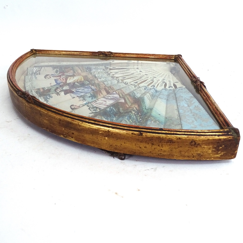 A 19th century Italian ivory fan, over-painted printed scenes, in glazed display case, case length - Image 3 of 3