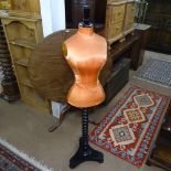 A Victorian Siegel & Stockman mannequin, recovered in orange silk, on an ebonised telescopic