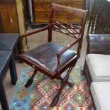 A hardwood desk chair, on X-shaped supports with brass inlaid table-top rail, W53cm