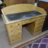 A Victorian pine knee-hole writing desk, with raised back, leather skiver and 9 short fitted drawers