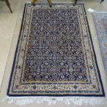 A blue ground Persian design rug with symmetrical decoration, 187cm x 126cm