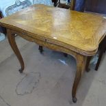 A small French oak and parquetry-topped draw leaf table of serpentine form, raised on cabriole legs,