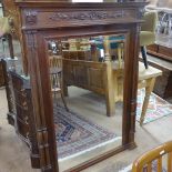 A French carved walnut-framed wall mirror, with fluted twin columns, height 5'8", width 3'7"