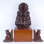 A pair of Oriental carved hardwood bookends, a graduated 3-tier corner hanging shelf, and a