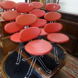 A set of 4 modern red upholstered swivel chairs on chrome legs