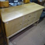 A hardwood and satin-walnut sideboard, by Gordon Russell for Heals, with 3 central short drawers